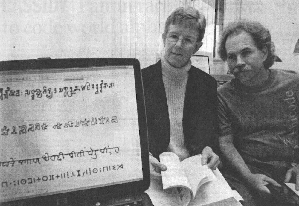 Debbie ANderson and Rick McGowan with a macbook displaying global writing systems